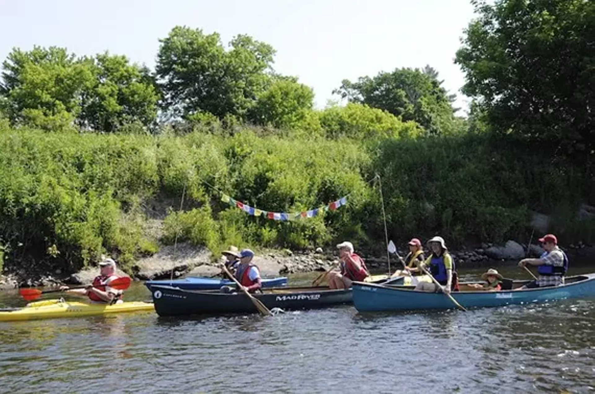 a7508bf0_canoeswithflags_copy.webp