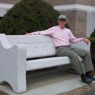 Eric Oberg on bench at Aldrich Library in Barre