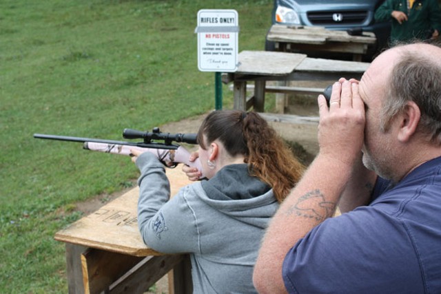 Amanda and Joe Corcoran sight a .22-caliber hunting rifle
