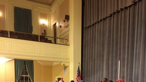CCTA bus driver Mike Walker speaks to the crowd inside Burlington City Hall Auditorium on Thursday night.