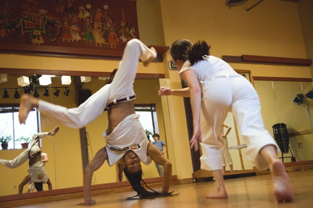 Fabio Nascimento and a student improvise a capoeira "fight" - MATTHEW THORSEN