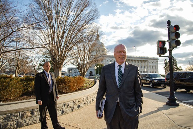 Leahy crosses the Capitol grounds with security in tow