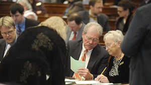 Members of the legislature's canvassing committee tally ballots.