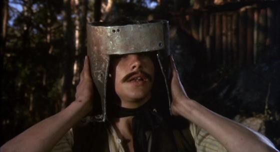Ned tests out his homemade helmet on a comrade - MGM PICTURES