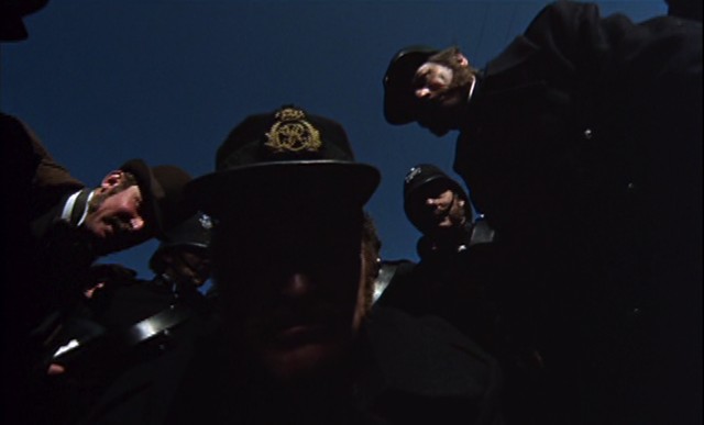 Ned's wide-angle POV as the policemen haul him into town - MGM PICTURES