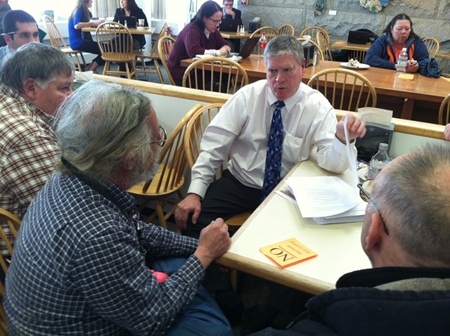 Senate President Pro Tempore John Campbell (D-Windsor) talks to Tim Ordway of Bennington (left) and other gun owners Tuesday in the Statehouse cafeteria. - TERRI HALLENBECK