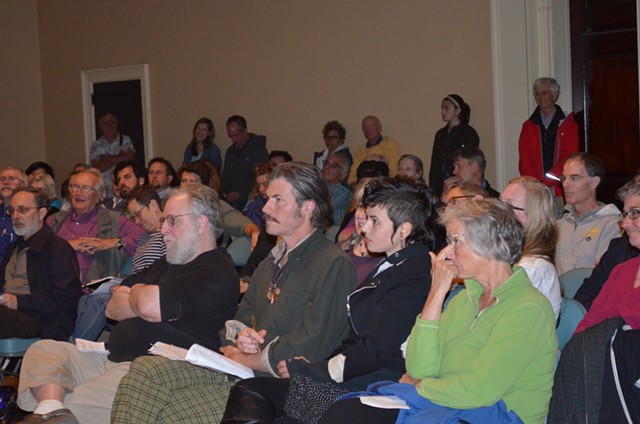 Burlington residents listen to Tom Angotti speak at Contois Auditorium. - ALICIA FREESE