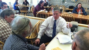Senate President Pro Tempore John Campbell (D-Windsor) talks to Tim Ordway of Bennington (left) and other gun owners Tuesday in the Statehouse cafeteria.