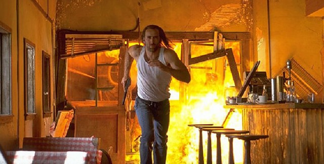 Nicolas Cage outrunning one of many explosions in Con Air - TOUCHSTONE PICTURES
