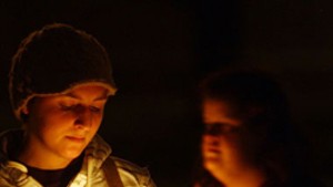 Nicole Proulx of Plainfield holds a candle during a “Take Back the Night” vigil in Montpelier