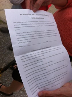 Rebecca Foster displays the official notice against trespass issued against the protestors. - KATHRYN FLAGG