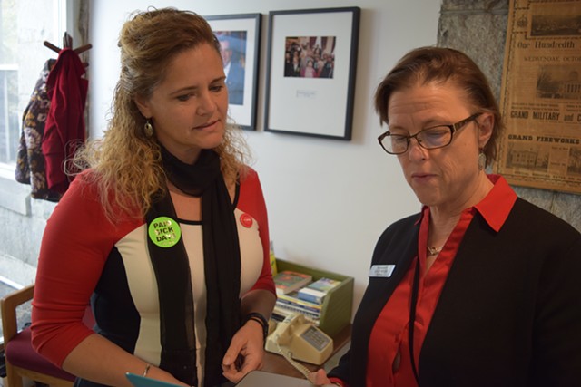 House Majority Leader Sarah Copeland Hanzas (D-Bradford), left, sports a sticker supporting a paid sick leave bill as she talks Tuesday with Assistant Majority Leader Kate Webb (D-Shelburne). - TERRI HALLENBECK