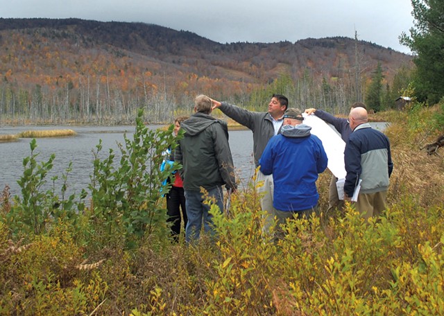 State officials and Adirondack Club and Resort representatives discussing the proposal alongside Cranberry Pond in 2011 - COURTESY OF JESSICA COLLIER OF THEADIRONDACK DAILY ENTERPRISE