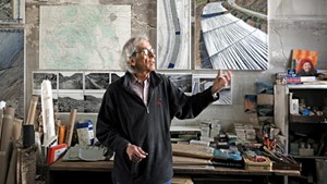 Christo in his studio with a preparatory collage for "Over the River," 2011