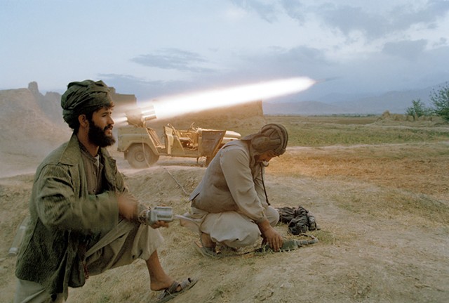 Taliban soldiers fire a rocket at retreating forces of the Northern Alliance army north of Kabul. - COURTESY OF ROBERT NICKELSBERG