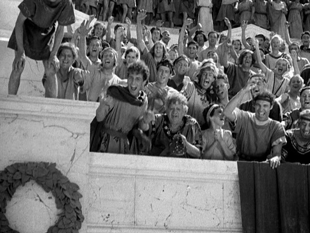 Though cheering for the actual spilling of blood, these spectators at a Pompeiian gladiator contest are generally more civilized than modern hockey fans. - WARNER BROS. PICTURES