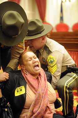 Vermont State Police remove Sheila Linton of Brattleboro from the chamber of the Vermont House. - JEB WALLACE-BRODEUR