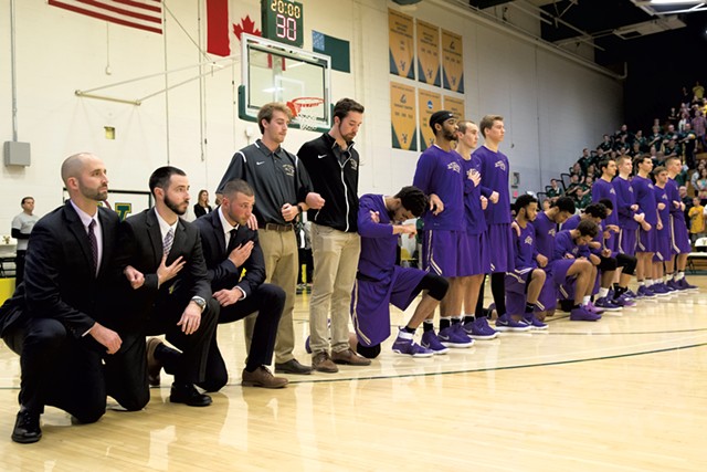 Saint Michael's College men's basketball players kneel during the anthem in an exhibition game at the University of Vermont - FILE: JAMES BUCK