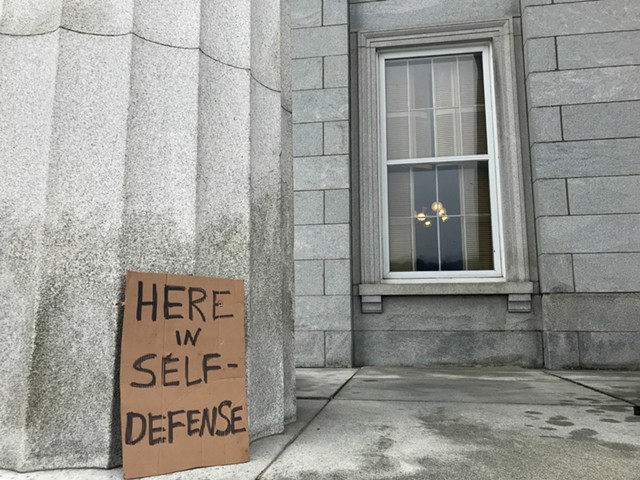 A gun control demonstrator left a sign outside the window of the Senate Judiciary Committee meeting room. - TAYLOR DOBBS