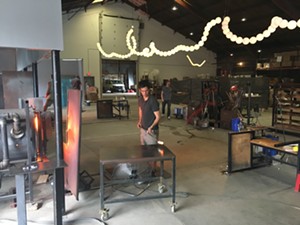 Tyler Vendituoli working in the new AO Glass studio. - SADIE WILLIAMS