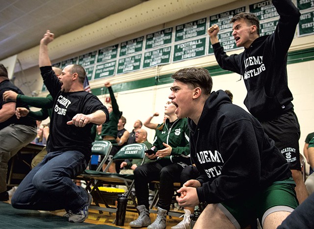 Ayman Alsalloumi (second from right) and Majd Alabas (right) cheering with their team during a meet - JAMES BUCK