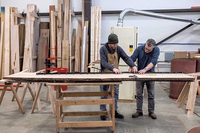 Greg Goodman and Tom Bodett working on a table at HatchSpace - ZACHARY P. STEPHENS