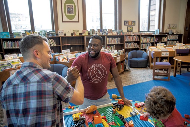 Dad Guild members Marlon Fisher (right) and Patrick Pierce greet each other at a library playgroup - JAMES BUCK