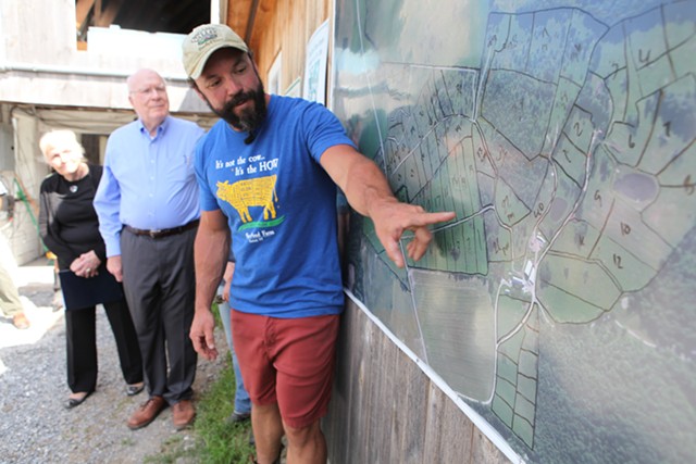 Stony Pond Farm owner Tyler Webb shows Leahy a map of the pastures on his 300-acre property. - KEVIN MCCALLUM