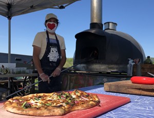 Tucker Levy manning the NOFA-VT pizza oven - JORDAN BARRY