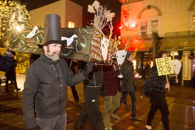 Glenn Eames carries a cardboard coffin to City Hall in protest of the Burlington College development agreement. - JAMES BUCK
