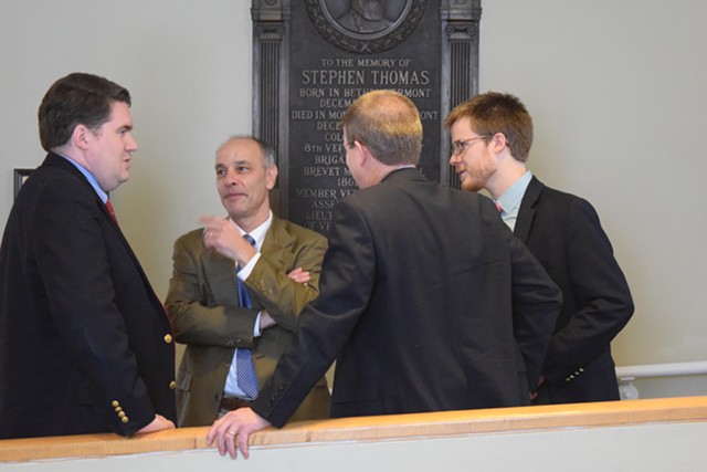 House Speaker Shap Smith (D-Morristown), back to camera, confers Friday afternoon with Reps. Oliver Olsen (I-Londonderry), left, and Adam Greshin (I-Warren) and Smith's aide, Dylan Giambatista. - TERRI HALLENBECK