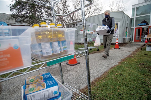 John Tuthill bringing a box of perishables to a customer's car at the Hardwick Area Food Pantry - JEB WALLACE-BRODEUR