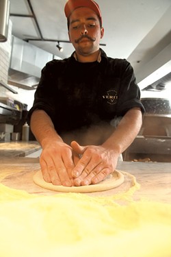 Griffeon Chuba pressing pizza dough. - MATTHEW THORSEN