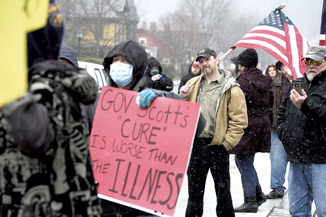 Kevin Hoyt holding a flag at a protest against quarantine lockdowns last year - FILE: JEB WALLACE-BRODEUR