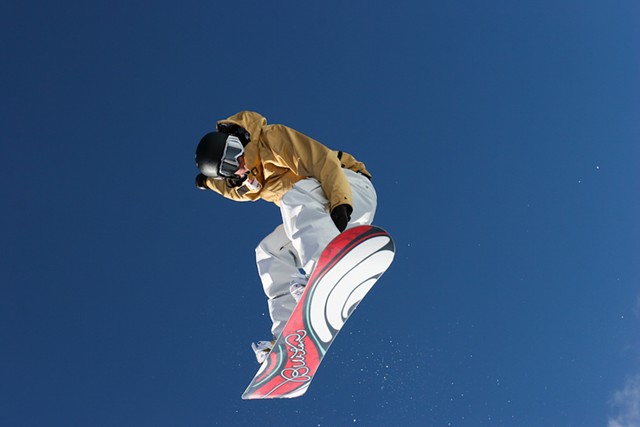 A snowboarder on a Burton board - LAGLIDER/DREAMSTIME