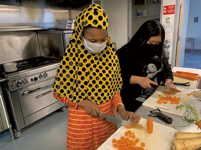 Hawa Aden (left) and Astha Magar chopping vegetables at the King Street Center - COURTESY OF DEENA MURPHY