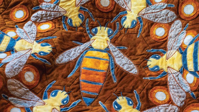 A detail of a bee-themed quilt featuring the hive's queen - GLENN RUSSELL