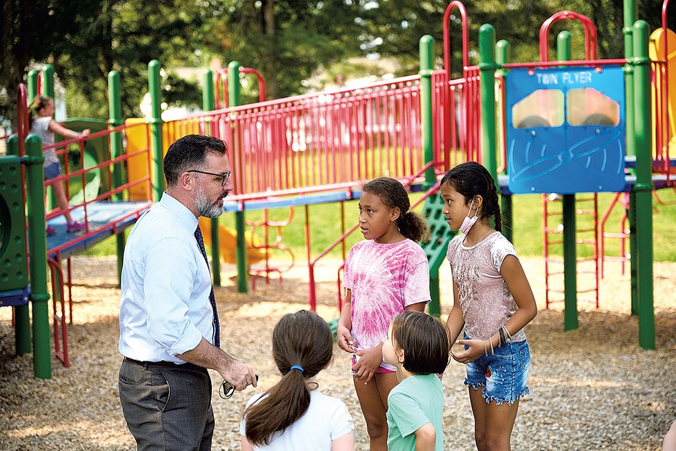 Tom Flanagan with students on the playground at C.P. Smith Elementary School - BEAR CIERI