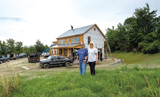 Phil and Debbie Gianelli in front of their Hinesburg home build - JAMES BUCK