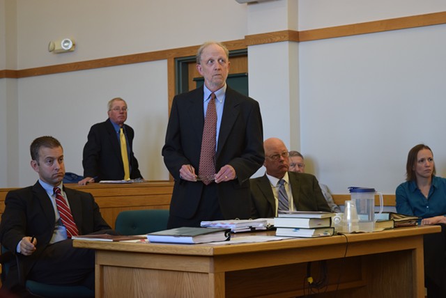 Defense attorneys David Williams (standing) and Brooks McArthur (left) argue motions Tuesday for Sen. Norm McAllister (right), a day before his sexual assault trial begins. - TERRI HALLENBECK