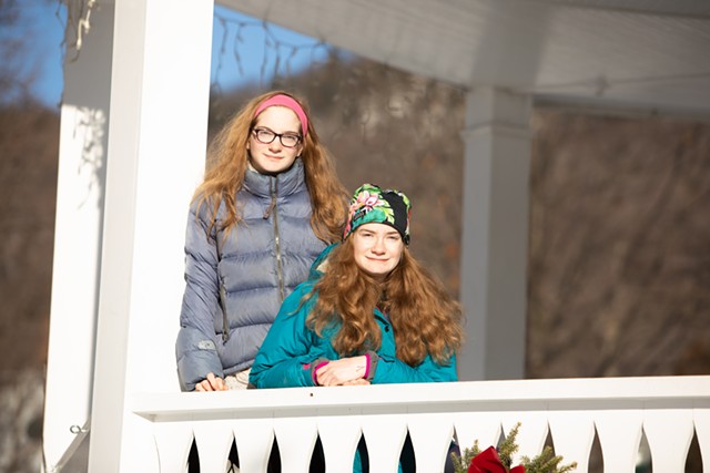 Eliza Doucet (seated) with her twin sister, Emma, at the Bristol Town Green on Jan. 16. - CAT CUTILLO