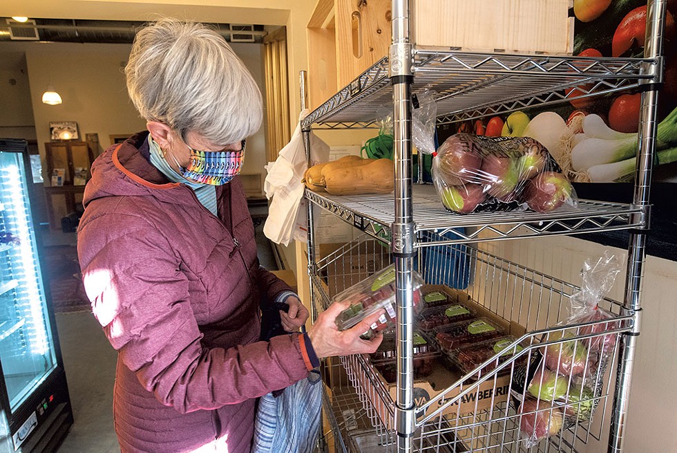 Cindy Allen, of Chelsea, picking up free produce at the Orange County Parent Child Center in Tunbridge - JEB WALLACE-BRODEUR