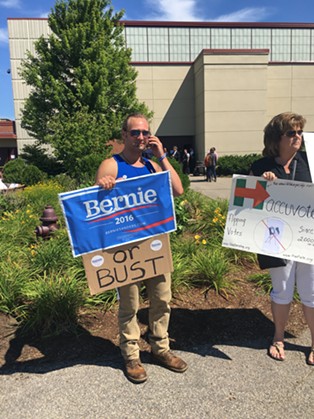 Clay King, left, protests Bernie Sanders' endorsement of Hillary Clinton Tuesday in Portsmouth, N.H. - PAUL HEINTZ