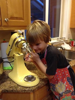 Theo, showing the (unplugged) KitchenAid a little love.
