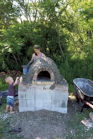 Russ and Katie build the oven - COURTESY OF KATIE TITTERTON