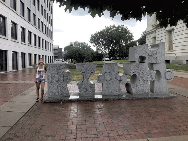 Grace Heller next to W.F. Herrick's sculpture "Democracy" in Burlington (Activity 50)