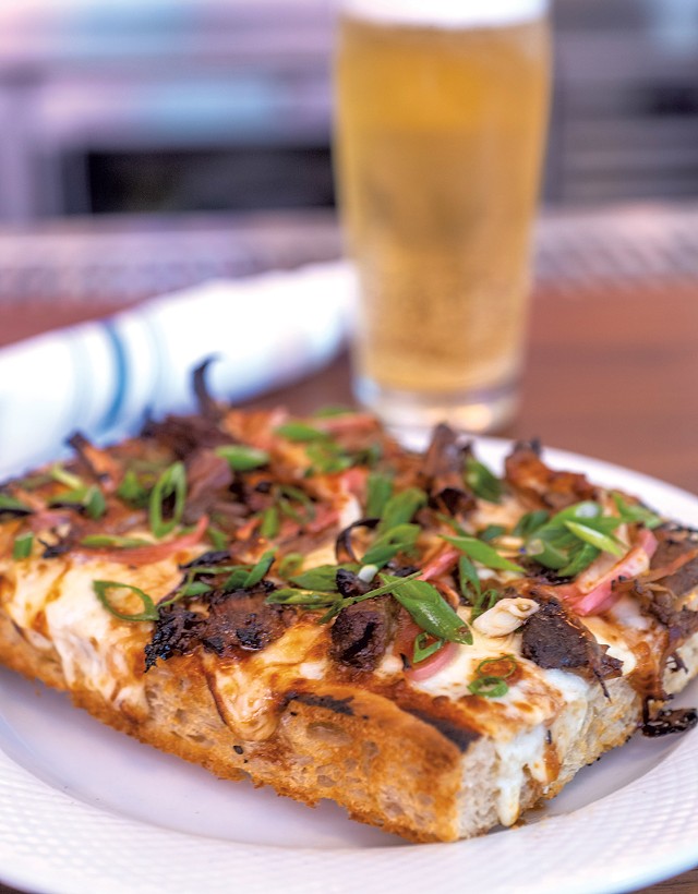 Grandma pizza slice with roast pork, pickled red onion, scallions and miso cream drizzle - JEB WALLACE-BRODEUR
