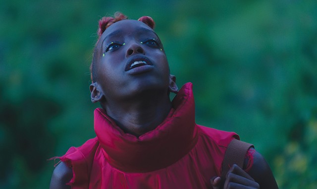 LADY IN RED Isheja lights up the screen in Williams and Uzeyman's mesmerizing Afrofuturist, cyberpunk musical. - COURTESY OF WHITE RIVER INDIE FILMS