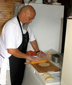 Manuel Aguilera making empanadas - ROBERT C. JENKS