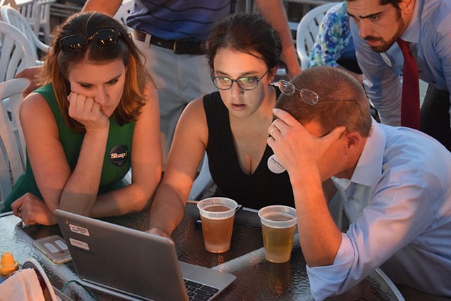 House Speaker Shap Smith reviews election results last Tuesday at Breakwater Café & Grill with campaign manager Erika Wolffing (left) and supporter Candace Morgan. - TERRI HALLENBECK